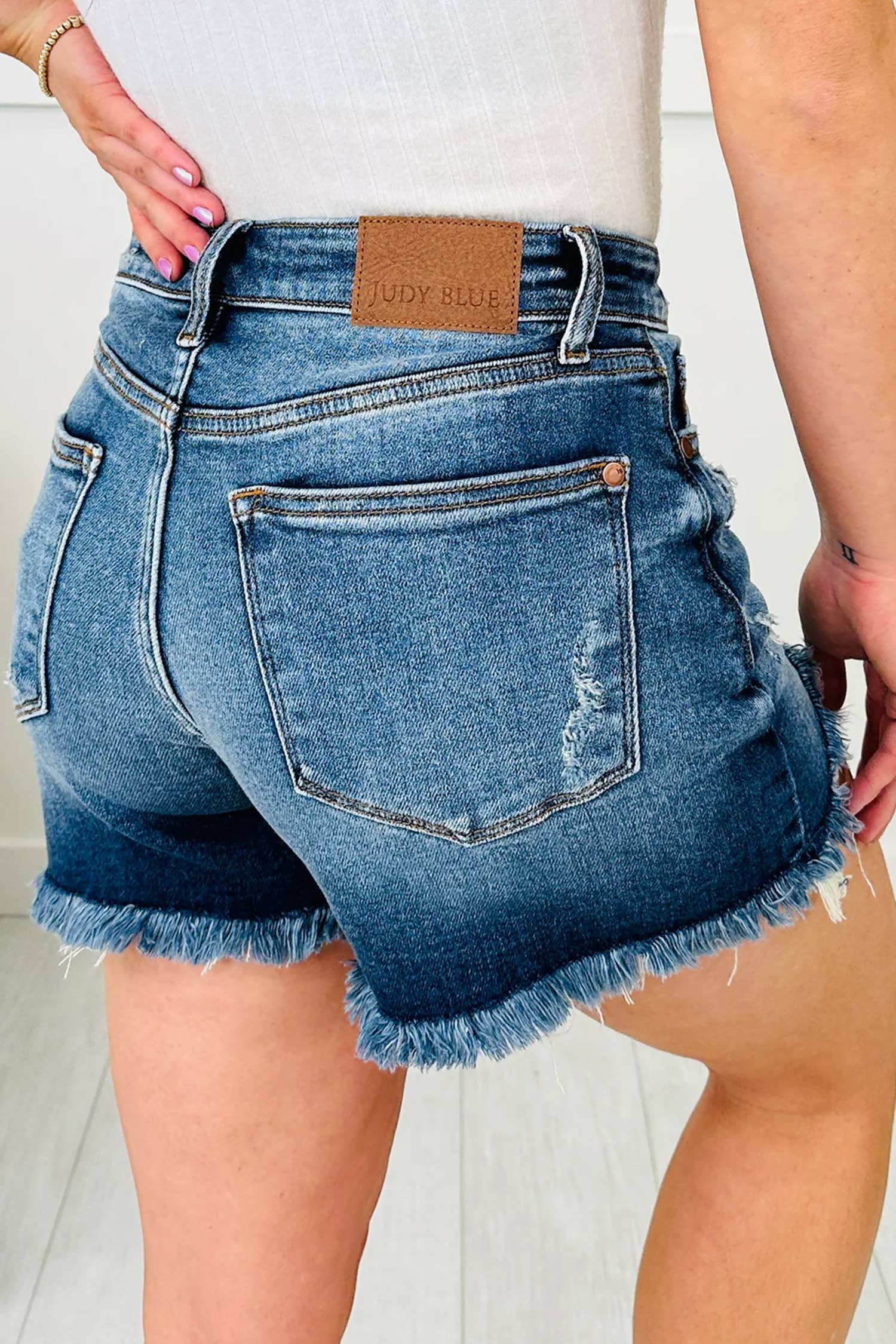 Asymmetric Raw Hem Distressed Denim Shorts